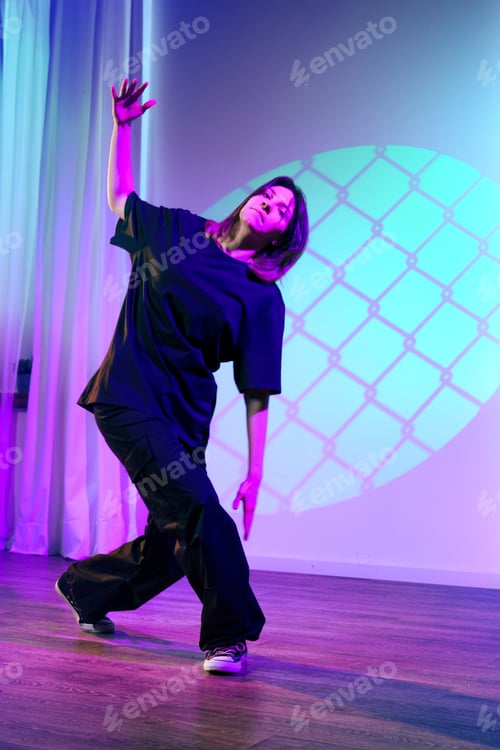 Preview: Creative dance performance with dramatic lighting at a contemporary studio