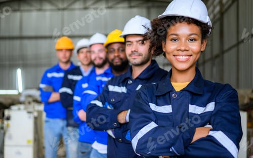 Preview: Group of professional engineers workers smiling to camera at factory