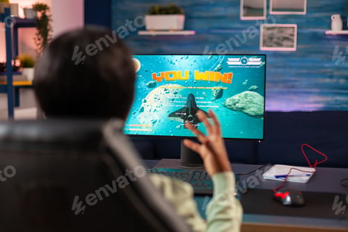 Preview: Competitive african gamer celebrating victory
