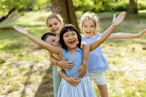 Preview: Group of asian and caucasian kids having fun in the park