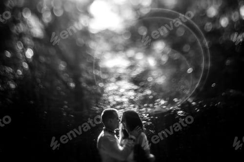 Preview: beautiful stylish brunette bride and elegant groom in embroidery costumes having fun in the park