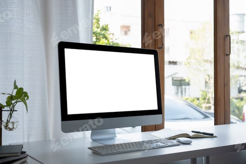 Preview: Modern workplace with computer, books and houseplant on white table.