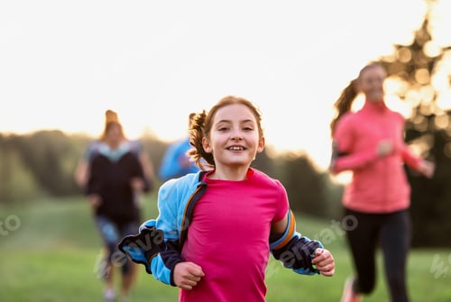 Vista previa: A portrait of small girl with large group of people running in nature
