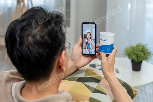 Preview: Asian mature patient talking virtual online with medical doctor on phone.