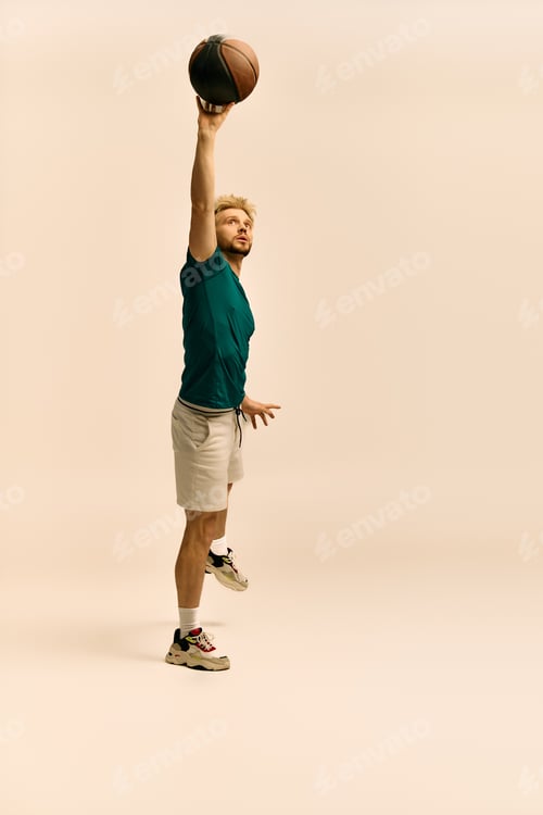 Preview: Dynamic young athlete showcasing his skills while shooting a basketball with precision indoors