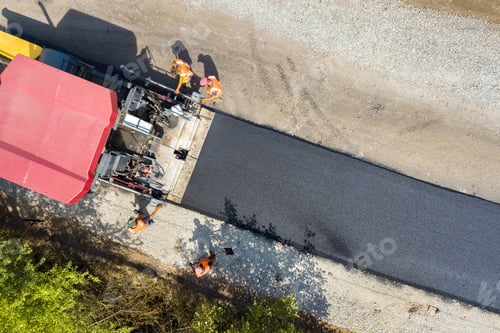 Preview: Aerial view of new road construction with asphalt laying machinery at work