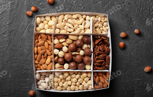 Preview: Different grade of nuts in a box on a wooden background top view
