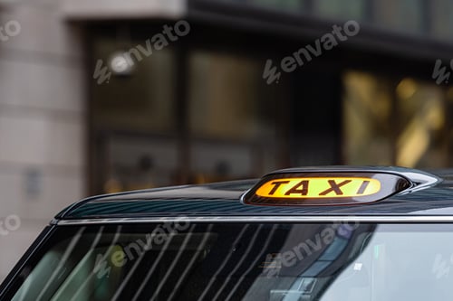 Preview: A british london black taxi cab sign with defocused background