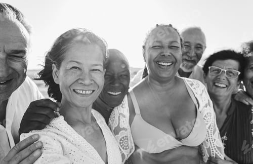 Preview: Happy senior people having fun on the beach at sunset time while wearing summer clothes
