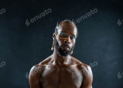 Preview: Confident african-american bearded gay wearing make up isolated on black