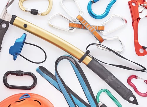 Preview: Climbing equipment for the safeness lying on the white table. Conception of extreme sports