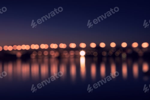 Preview: Background with blurred lights of lanterns at night. reflection of bokeh in river. Toulouse, France