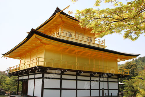 Preview: Architecture of Kinkakuji temple in Kyoto, Japan, illuminated by warm light against a clear blue sky