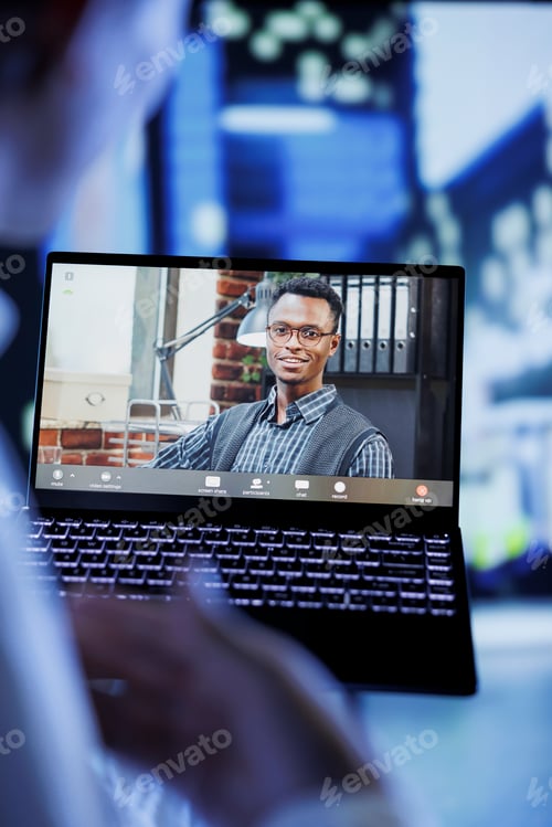 Preview: Man videocalls coworker, close up