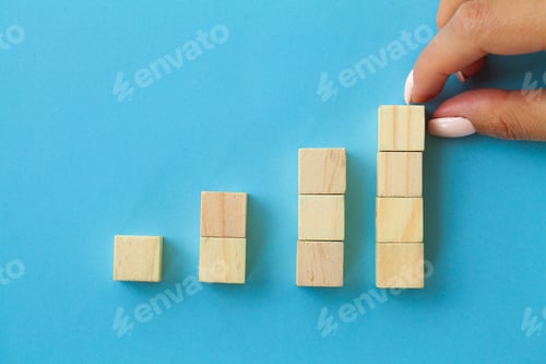 Preview: Hand arranging wood block with empty space.