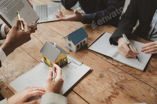 Preview: Real Estate Professionals Reviewing Documents at Workplace