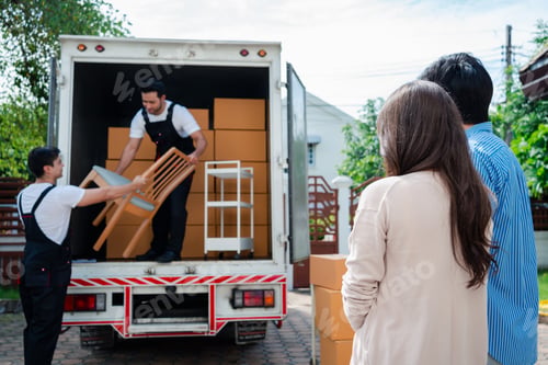 Preview: Asian Couple check while unloading boxes and furniture from a pickup truck