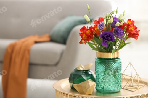 Preview: Glass vase with fresh flowers on table in living room. Space for text