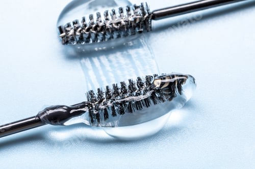 Preview: Close-up of transparent eyelash eyebrow gel serum, smooth and shiny texture stroke, blue background
