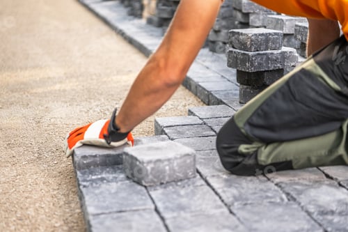 Preview: Laying Paving Stones on a Pathway in Bright Daylight