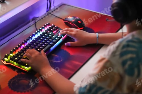 Preview: Gamer. A teenager is playing on the computer in the room.Keyboard computer,using technology