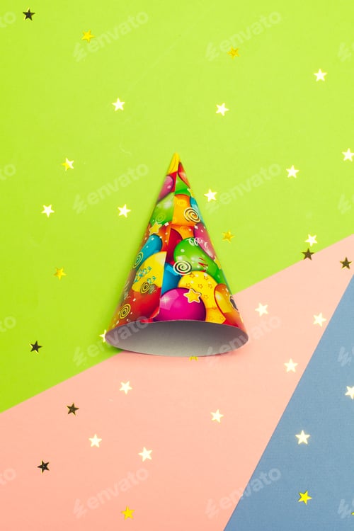 Preview: Colorful party hat on vibrant background with confetti scattered around