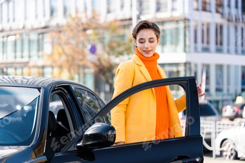 Preview: Beautiful young woman with short hair drives car in the city