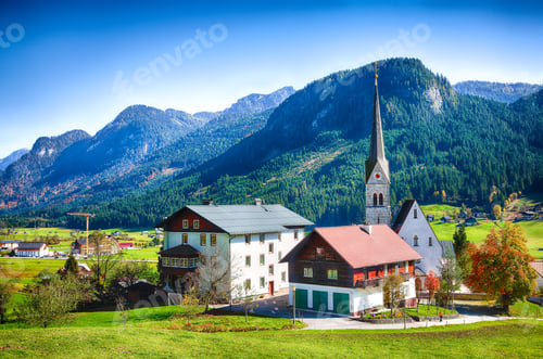 Preview: Alpine green fields and traditional wooden houses view of the Gosau village at autumn sunny day.