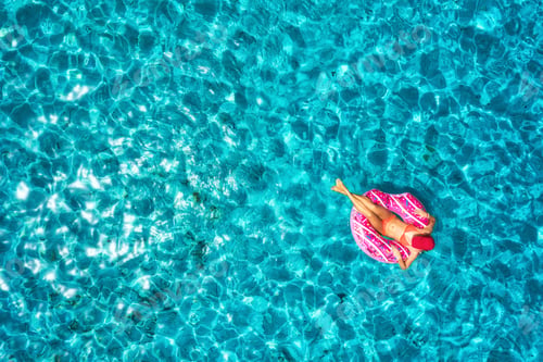 Preview: Aerial view of woman on the swim ring in the sea