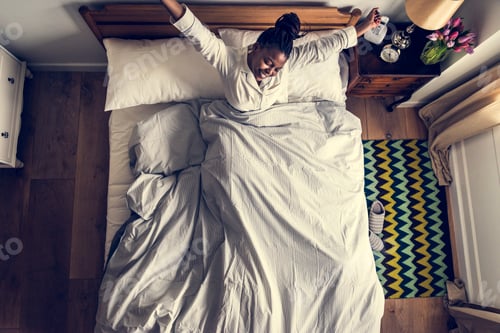 Preview: African American woman on bed waking up in the morning