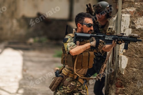 Preview: Few brave soldiers with rifles in action during rescue operation.