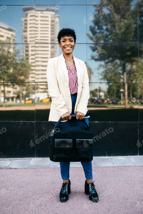 Preview: Woman with laptop bag looking at camera