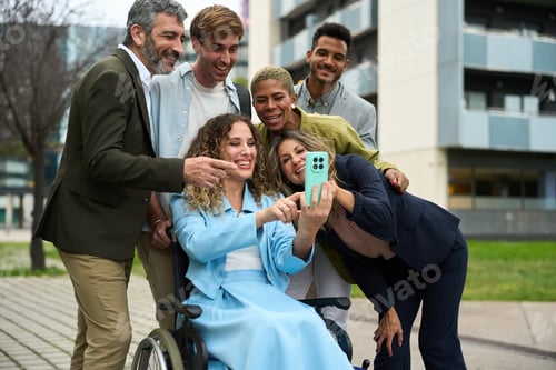 Preview: Diverse colleagues taking selfie together in urban setting