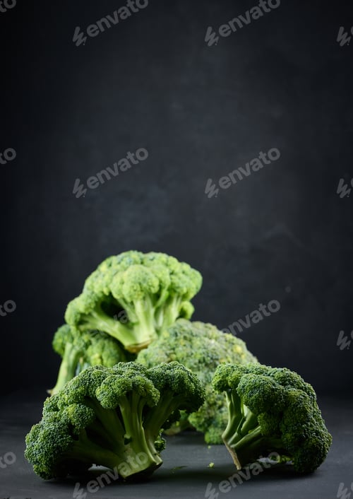 Preview: Fresh green head of broccoli on black background
