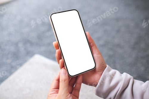 Preview: Mockup image of a woman holding and using mobile phone in the outdoors