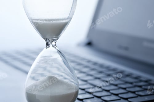 Preview: Hourglass and laptop keyboard, online time concept.