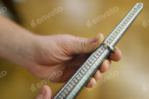 Preview: Goldsmith's hand measuring the size of a ring.