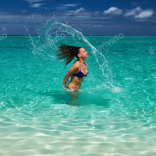 Preview: Woman Splashing Water With Her Hair In The Ocean