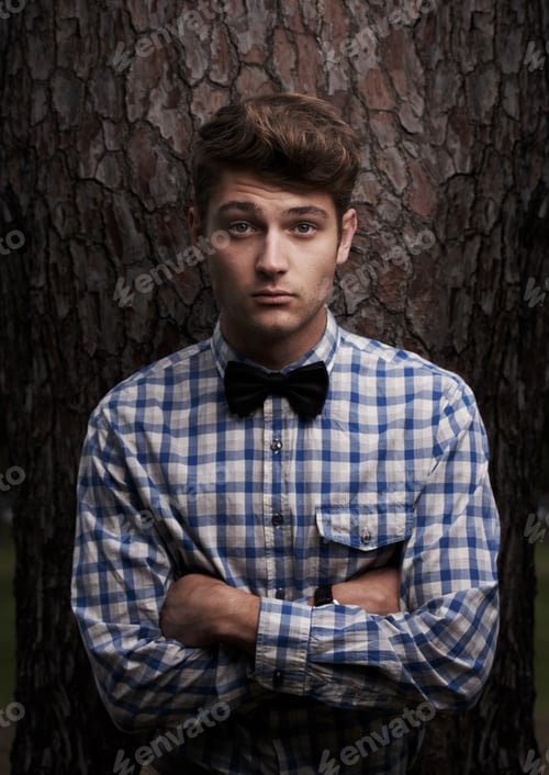 Preview: Portrait of an outdoor hipster. Shot of a handsome young hipster standing in front of a tree.