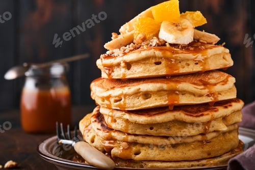 Preview: Pancakes. Homemade fluffy pancake with banana, walnut and caramel for breakfast on dark wooden backg