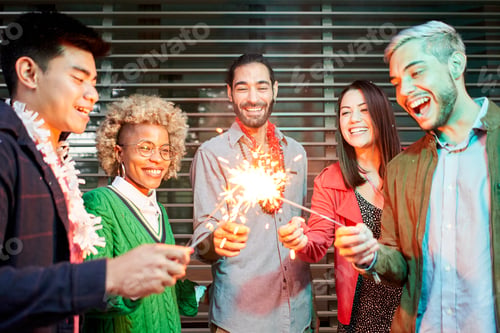 Preview: Multi-ethnic millennial group of friends folding sparklers.