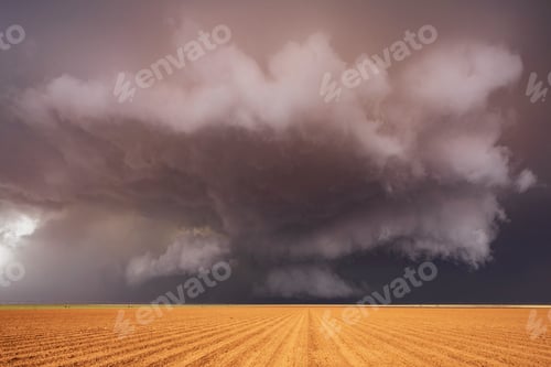 Preview: Tornado-Producing Supercell, clouds gathering above a cornfield, dark shapes on the horizon.