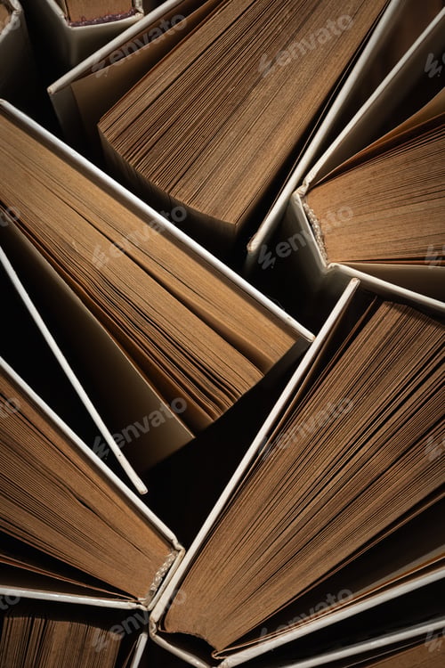 Preview: Background of many open old vintage hardback paper books. Library archive