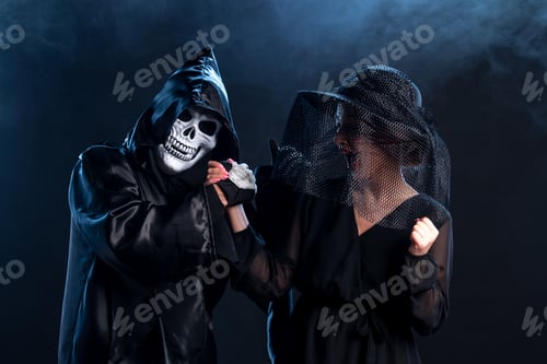 Preview: young woman dressed in black flirting with death itself on dark background funeral grim reaper
