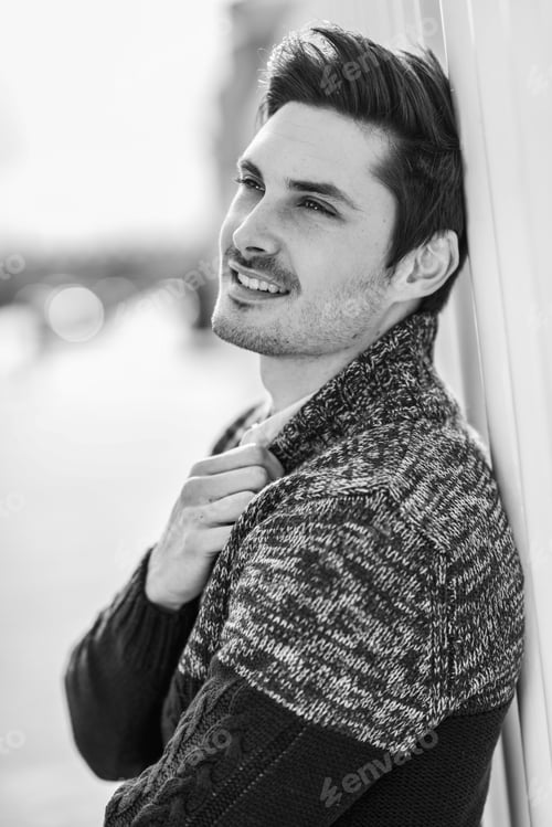 Preview: Attractive young handsome man, model of fashion in urban backgro