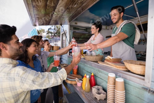 Preview: Waitress and waiter giving juice to customer at counter