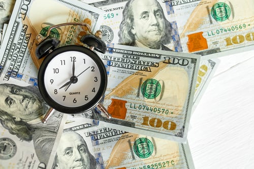 Preview: Top view flat lay of Alarm clock and money on white wooden background