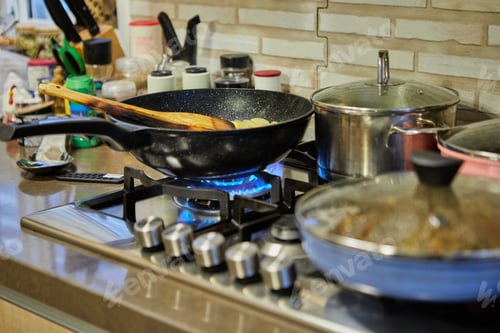 Preview: Pots with cooking food in the kitchen on gas stove