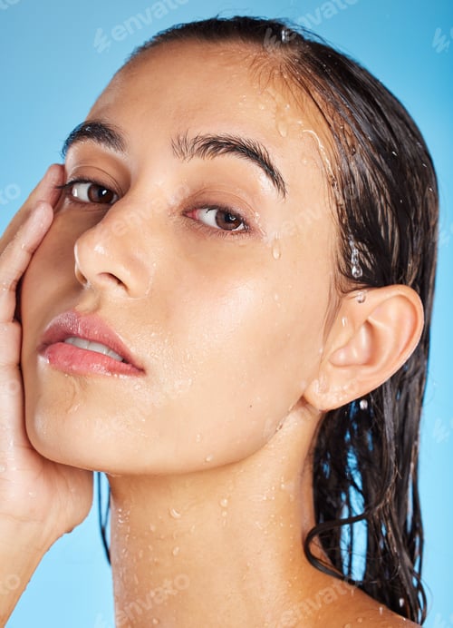 Preview: Portrait, water and woman cleaning, skincare and dermatology for health, wellness and on blue studi