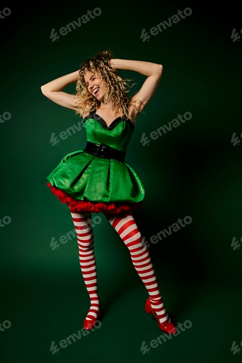 Preview: happy new year elf in green dress posing with arms raised touching hair on dark green backdrop